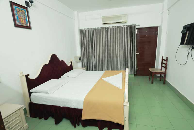 An AC room with wooden headboard